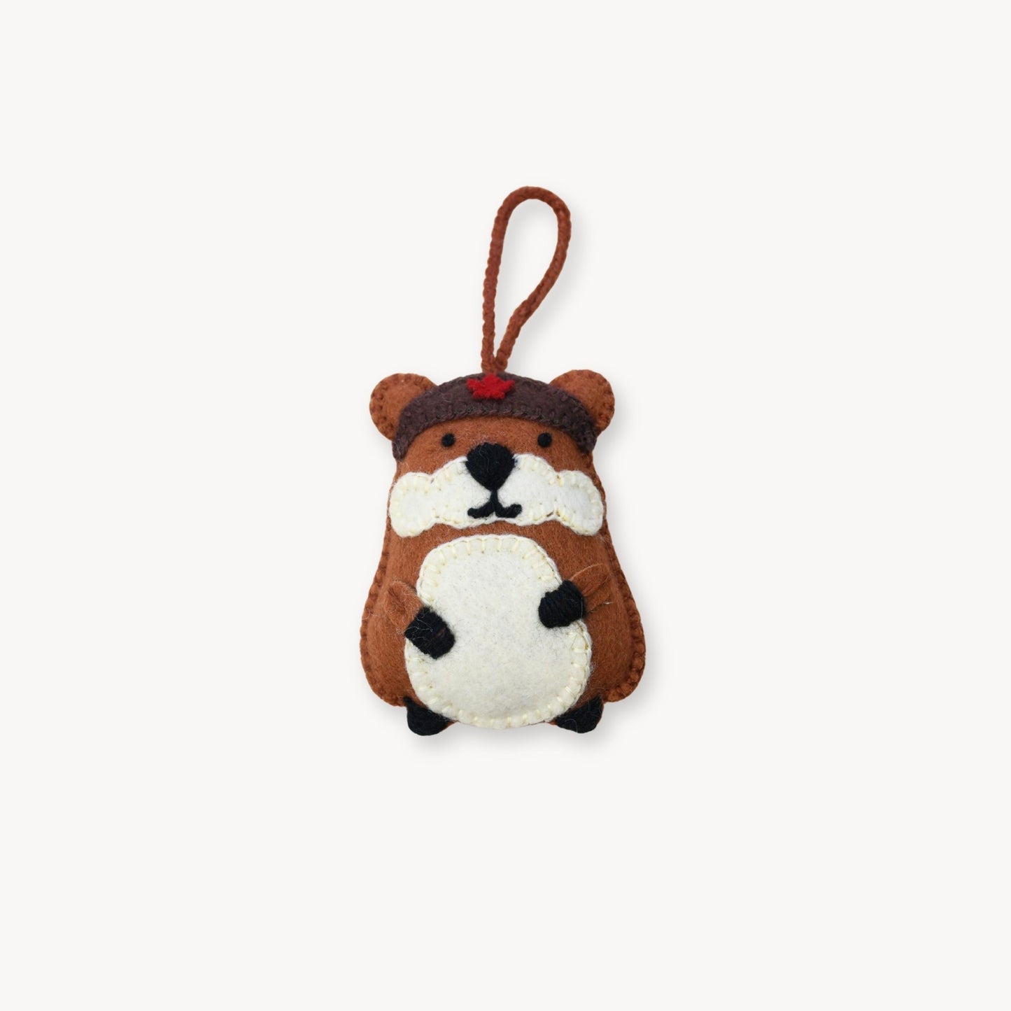 Small plush toy resembling a hamster with a helmet on a white background